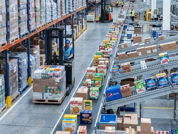 Conveyor moving packaged FMCG goods through a high-volume distribution warehouse